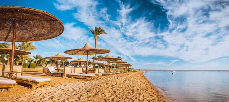 Beautiful beach in Hurghada with umbrellas and clear blue sky